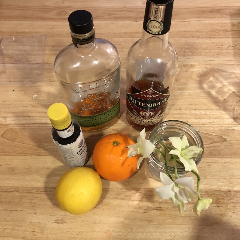rye whiskey bottles next to citrus fruit